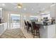 Open kitchen with an island, bar stools, and an adjacent sunroom with lake views at 2562 Sheffield Dr, Deltona, FL 32738