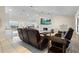 Open-concept living room features tile flooring, a cozy fireplace, and scenic water views at 2562 Sheffield Dr, Deltona, FL 32738