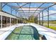 Inviting pool area within a screened enclosure, overlooking scenic lake views at 2562 Sheffield Dr, Deltona, FL 32738