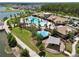 Expansive aerial view showcasing community pool, water park, clubhouse, and lake amenities within a residential neighborhood at 2598 Trielle Ave, Kissimmee, FL 34741