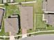 Aerial view of backyard with manicured lawn, complimented by neighboring houses and greenery at 2598 Trielle Ave, Kissimmee, FL 34741