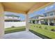 Covered patio overlooking a well-maintained backyard with white fence and lush green grass at 2598 Trielle Ave, Kissimmee, FL 34741