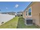Spacious backyard featuring a well-kept lawn, white fence, and a modern home exterior at 2598 Trielle Ave, Kissimmee, FL 34741