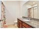 Bathroom featuring granite countertop, vanity and shower with tropical themed curtain at 2598 Trielle Ave, Kissimmee, FL 34741