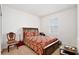 A bedroom with a cozy bed, a window providing natural light, and minimalistic decor at 2598 Trielle Ave, Kissimmee, FL 34741