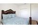 Comfortable bedroom with ornate wood bed frame and patterned blue comforter set at 2598 Trielle Ave, Kissimmee, FL 34741