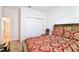 A bedroom with a double bed, closet, and bedside chair at 2598 Trielle Ave, Kissimmee, FL 34741
