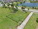 Aerial shot of fenced dog park with grassy area and walking path in a well-maintained community at 2598 Trielle Ave, Kissimmee, FL 34741