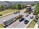 The neighborhood entrance featuring stone sign, a guard house, and lush landscaping at 2598 Trielle Ave, Kissimmee, FL 34741