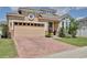 Charming home with brick driveway, two car garage, and well maintained landscaping at 2598 Trielle Ave, Kissimmee, FL 34741