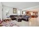 Spacious living room with a large, comfortable leather sectional and tile flooring throughout at 2598 Trielle Ave, Kissimmee, FL 34741
