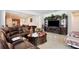 Comfortable living room featuring a plush leather sectional and an entertainment center at 2598 Trielle Ave, Kissimmee, FL 34741