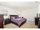 A well-lit main bedroom boasts large windows, a plush carpet, and a comfortable king-sized bed at 2598 Trielle Ave, Kissimmee, FL 34741