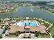 Beautiful community pool featuring palm trees, lounge chairs, and a clubhouse at 2598 Trielle Ave, Kissimmee, FL 34741