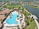 The community pool and recreation area featuring spacious seating, splash pad, and lush landscaping at 2598 Trielle Ave, Kissimmee, FL 34741