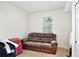 Cozy room showcasing a brown leather sofa and a window with natural light at 2598 Trielle Ave, Kissimmee, FL 34741