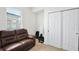 Comfortable room featuring a brown sofa and a bright window with natural light at 2598 Trielle Ave, Kissimmee, FL 34741