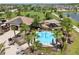 Aerial view of a water park with splash pad, playground, and seating area in a Gathering-friendly neighborhood at 2598 Trielle Ave, Kissimmee, FL 34741