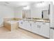 Bathroom with double sink vanity and a separate soaking tub at 3018 Bargate St, Orlando, FL 32824