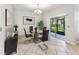 Dining area featuring modern glass table, sleek black chairs, sliding door to patio, and tile flooring at 3018 Bargate St, Orlando, FL 32824