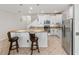 Bright kitchen featuring white cabinetry, stainless steel appliances, a breakfast bar with seating, and tiled floors at 3018 Bargate St, Orlando, FL 32824