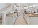 Galley kitchen with white cabinets, granite countertops, stainless steel appliances, and a tiled floor at 3018 Bargate St, Orlando, FL 32824