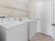 Practical laundry room featuring a washer, dryer, and overhead shelving at 3018 Bargate St, Orlando, FL 32824