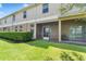 View of the covered screened-in patio with a seating area and well-maintained lawn at 3018 Bargate St, Orlando, FL 32824