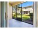 A screened-in patio providing a tranquil view of the home's manicured lawn at 3018 Bargate St, Orlando, FL 32824