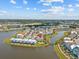 Beautiful aerial view of a waterfront resort community with colorful homes and scenic waterways under a sunny sky at 3020 Parrot Head Pl, Kissimmee, FL 34747