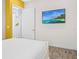 Cozy bedroom with a wall-mounted TV and a view into the bathroom, offering convenience and relaxation at 3020 Parrot Head Pl, Kissimmee, FL 34747
