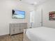 Neutral bedroom offering a mounted flat screen television and a view of an adjoining room at 3020 Parrot Head Pl, Kissimmee, FL 34747