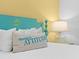 Bedroom featuring a turquoise headboard with a palm tree motif and a 'Changes in Attitude' pillow at 3020 Parrot Head Pl, Kissimmee, FL 34747