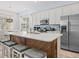 Bright kitchen with an island with barstool seating, modern appliances, and stylish backsplash for a chef's dream at 3020 Parrot Head Pl, Kissimmee, FL 34747