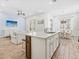 Open kitchen features white cabinets, island with seating, and stainless steel appliances perfect for modern living at 3020 Parrot Head Pl, Kissimmee, FL 34747