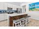 Charming kitchen featuring a spacious island with seating, stainless steel appliances, and modern finishes for a stylish home at 3020 Parrot Head Pl, Kissimmee, FL 34747