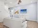Inviting living room with light blue walls, wooden floors, coastal decor, and ample seating at 3020 Parrot Head Pl, Kissimmee, FL 34747