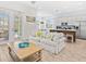 Bright living room featuring a comfortable couch, modern kitchen, and access to outdoor patio at 3020 Parrot Head Pl, Kissimmee, FL 34747