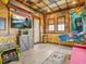 Fun themed living room with bamboo walls, entertainment center, and arcade games at 3020 Parrot Head Pl, Kissimmee, FL 34747
