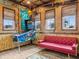 Fun themed living room with bamboo decor, pinball machine, and bright windows at 3020 Parrot Head Pl, Kissimmee, FL 34747