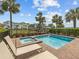Relaxing backyard with a private pool, hot tub, and comfortable lounge chairs at 3020 Parrot Head Pl, Kissimmee, FL 34747