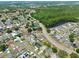 Bird's eye view of a home in a landscaped community near ponds, trees, and green recreational areas at 3029 Bransbury Ct, Kissimmee, FL 34747