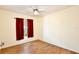 Well-lit bedroom features wood-look floors, large window, and neutral walls at 3029 Bransbury Ct, Kissimmee, FL 34747