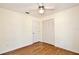 This bedroom has wood-look floors, a ceiling fan, and a double-door closet at 3029 Bransbury Ct, Kissimmee, FL 34747