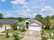 Beautiful home showcasing meticulous landscaping, a two-car garage, and an inviting entrance at 3029 Bransbury Ct, Kissimmee, FL 34747