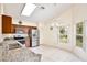 Well-lit kitchen with stainless steel appliances, granite countertops, ample cabinet space, and a tile floor at 3029 Bransbury Ct, Kissimmee, FL 34747