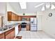 Modern kitchen featuring stainless steel appliances, updated cabinets, granite countertops, and tile flooring at 3029 Bransbury Ct, Kissimmee, FL 34747