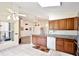 Updated kitchen with wood cabinets, granite countertops, stainless appliances, and a tile backsplash overlooking the main living space at 3029 Bransbury Ct, Kissimmee, FL 34747
