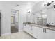 Bright bathroom features a double sink vanity with granite countertops, a large mirror, and a glass-enclosed shower at 30369 Apricot Ave, Eustis, FL 32736