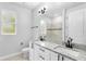 Bathroom with double granite vanity, sleek fixtures, and a separate shower area, blending luxury and functionality at 30369 Apricot Ave, Eustis, FL 32736